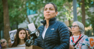 National Nurses United Endorses Dr Aisha Wahab for Congress in - USA Works Dr. Aisha Wahab outside, at podium