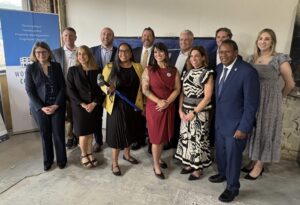 Shapiro-Administration-Celebrates-Continued-Progress-in-Downtown-Pittsburghs-Revitalization-scaledjjpeg - USA Works - USA Works A group of professionally dressed adults posing for a photo at an indoor event, smiling for the camera.