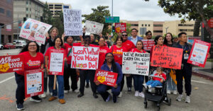 RNs protest layoffs at California hospitals warn of compromised care - USA Works - USA Works Large group of nurses outside hospital holding signs calling for patient safety and other measures