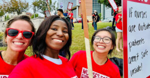 Baltimore Nurses Secure First Union Contract with Patient Safety Focus - USA Works - USA Works 3 nurses outside hospital smiling, wearing red
